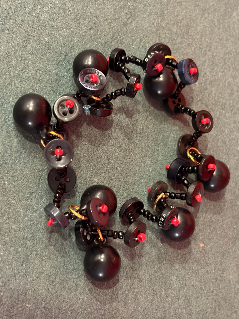 Unique Bracelet of Black Beads and Buttons with Red Accents